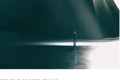 Small figure in spotlight on reflective water — placeholder editorial cover.
